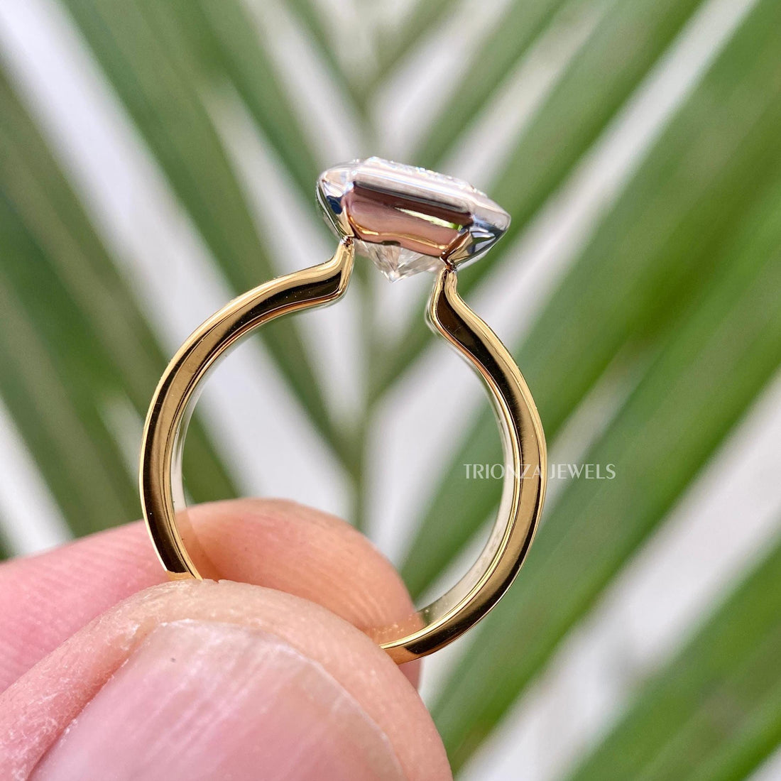 Radiant cut moissanite solitaire engagement ring in 14K two tone gold with bezel setting