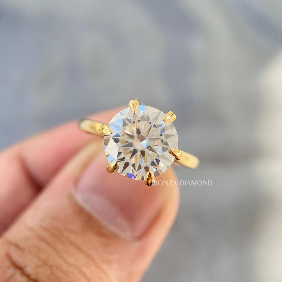Yellow gold engagement ring displayed to highlight its timeless solitaire design