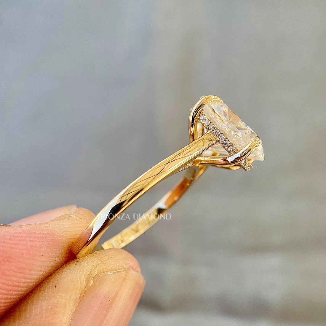 Oval lab grown diamond engagement ring with hidden halo set in 14k yellow gold