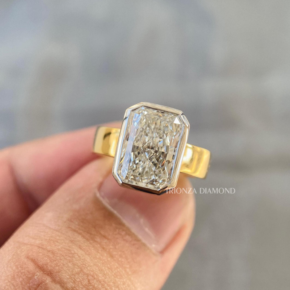 Handcrafted radiant diamond ring showing the E color and VS1 clarity brilliance