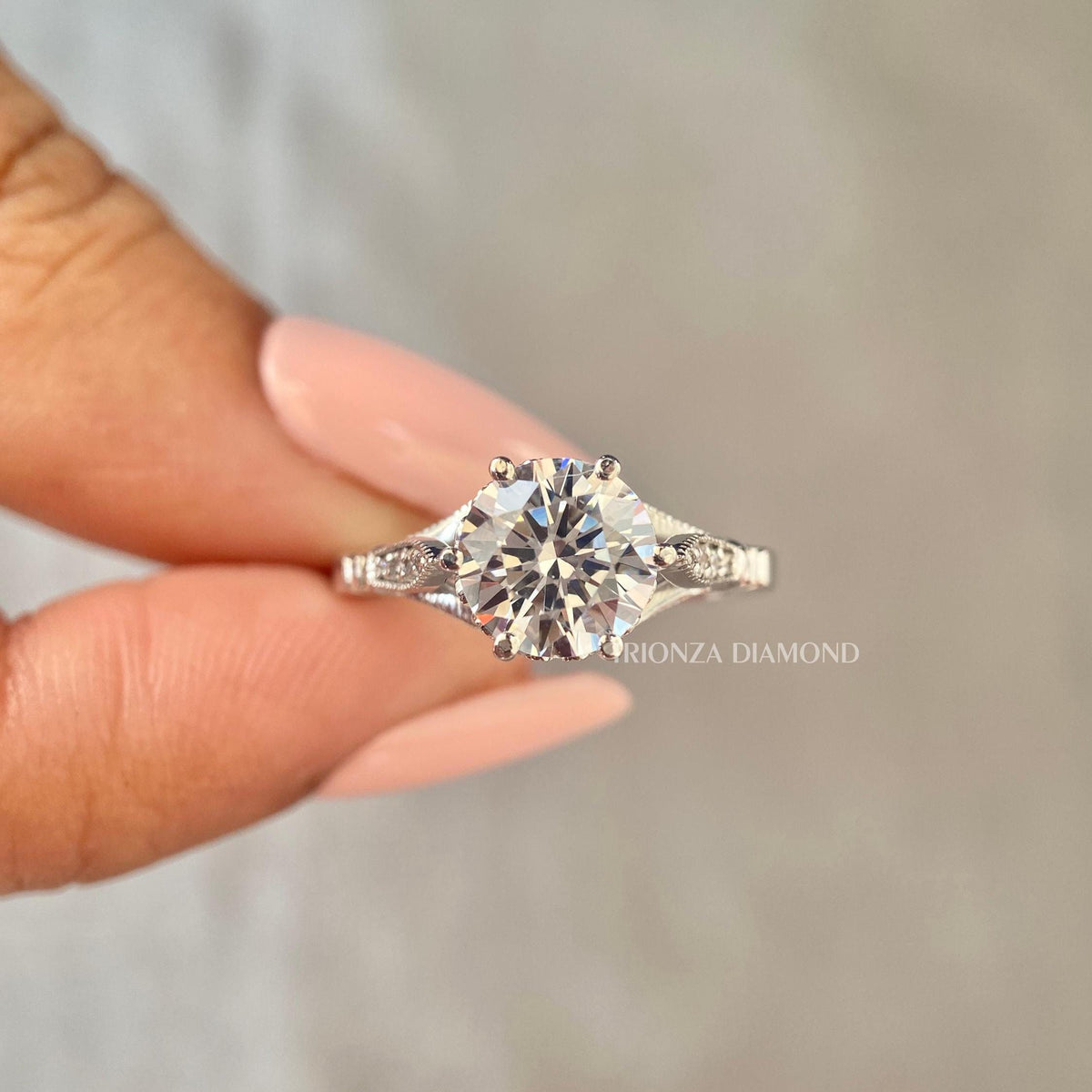 Close-up of the milgrain and pave detailing surrounding the 2 CT round center diamond