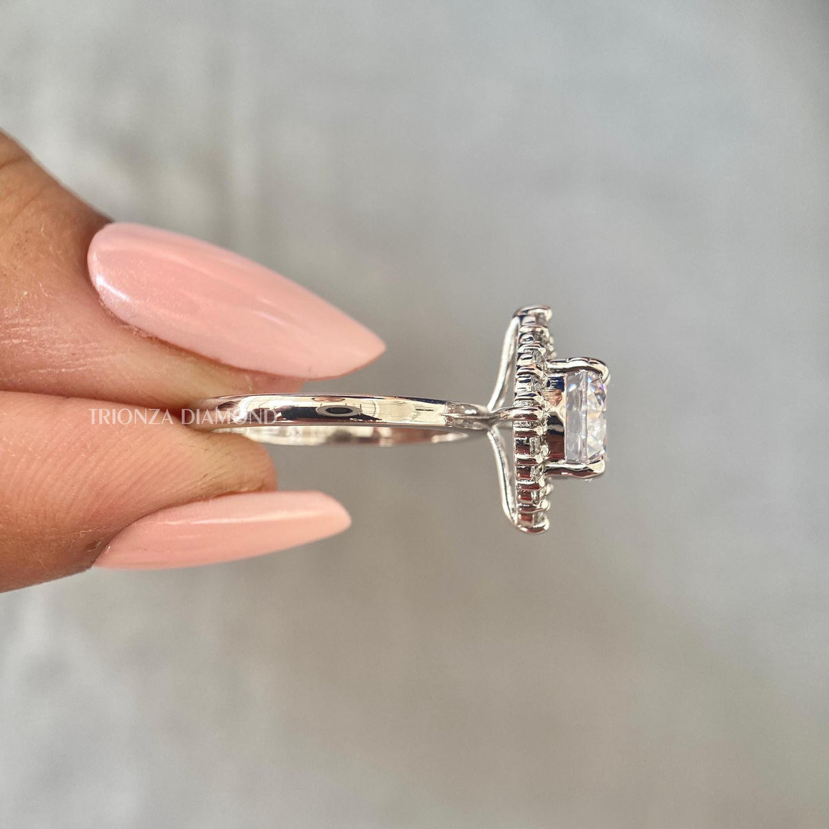 Woman wearing the round diamond halo ring, displayed for a natural sunlight shot