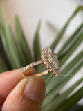 Close-up of the marquise pave halo setting showcasing colorless VVS clarity moissanite