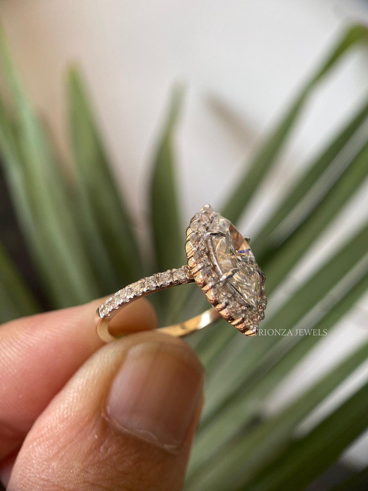 Close-up of the marquise pave halo setting showcasing colorless VVS clarity moissanite