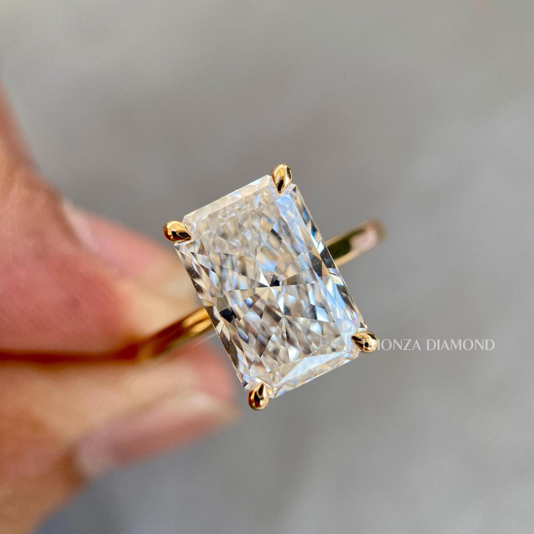 Radiant cut lab grown diamond ring featuring a 4 CT D color VVS2 center stone in 14k gold