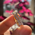 Close-up of the white prong setting securing the 2.00 CT oval diamond with side stone accents