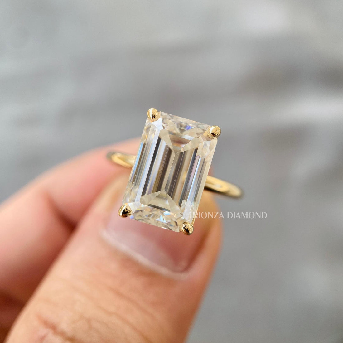 Emerald cut lab grown diamond engagement ring showcasing a 4 carat D color center stone
