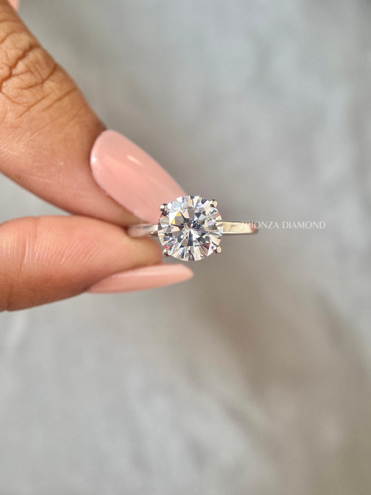 Round cut lab grown diamond solitaire ring featuring a 2 CT E/VVS center stone