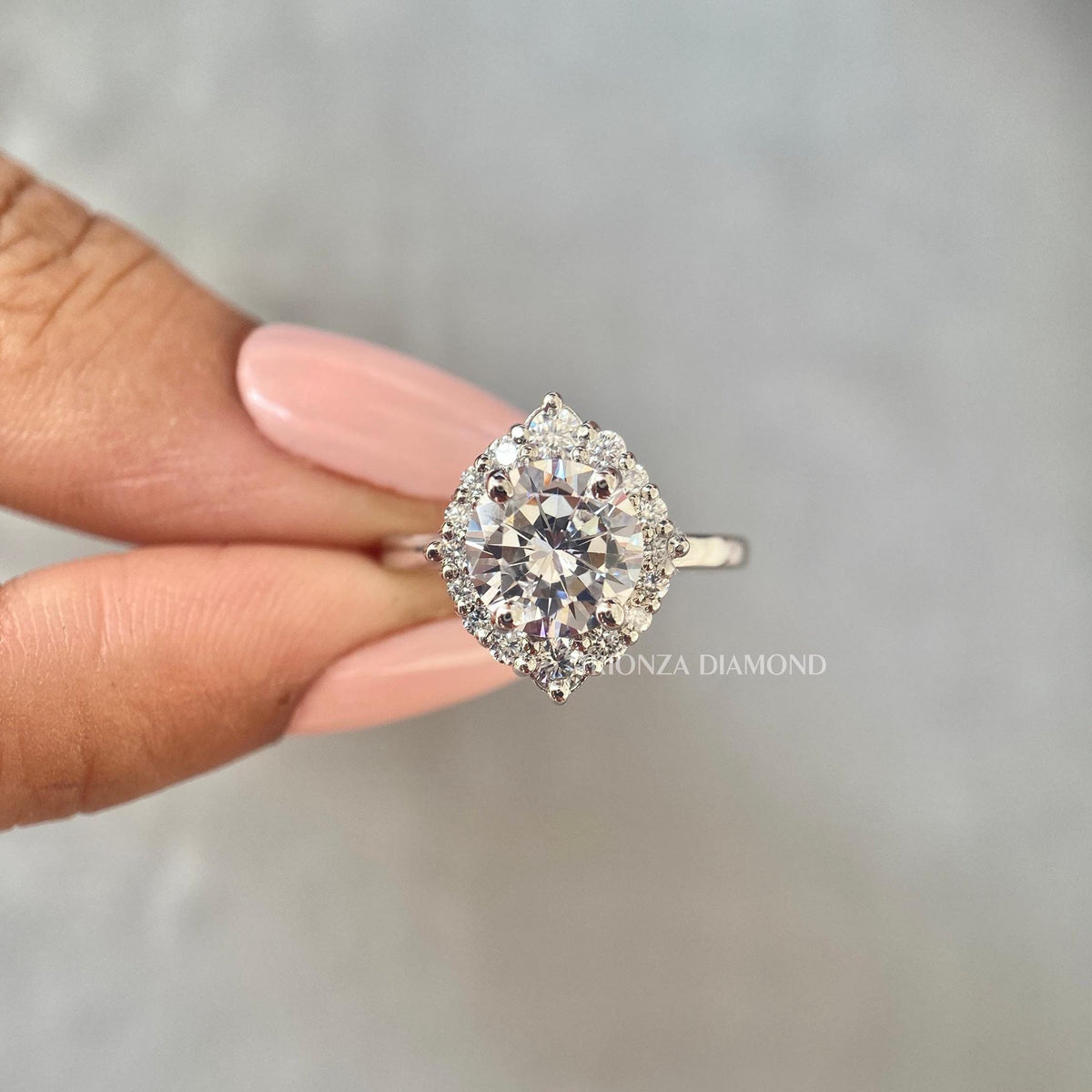 Close-up of the halo setting surrounding the 8mm round cut diamond in solid gold