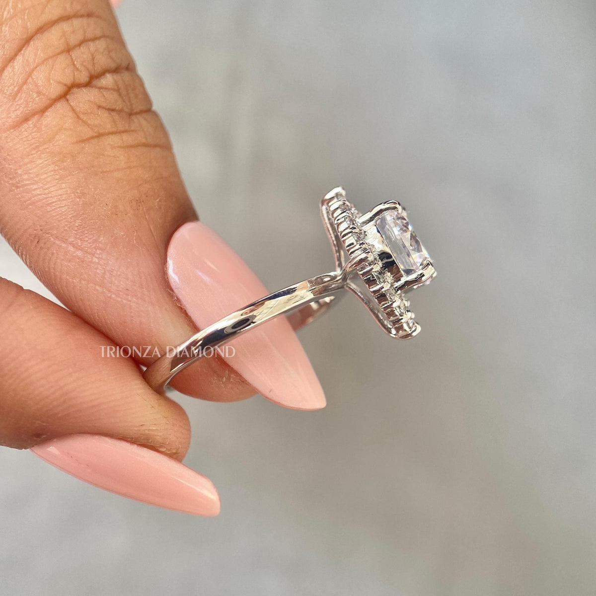 Side view of the halo engagement ring highlighting the 0.90 carat accent diamonds