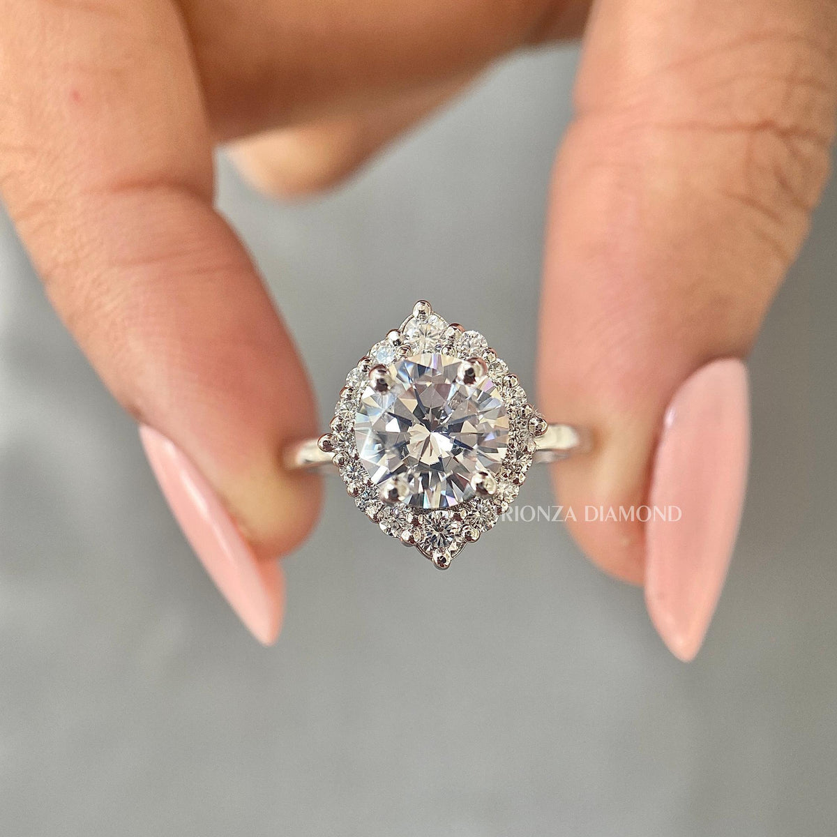 Round lab grown diamond halo engagement ring showcasing a sparkling 2 carat center stone