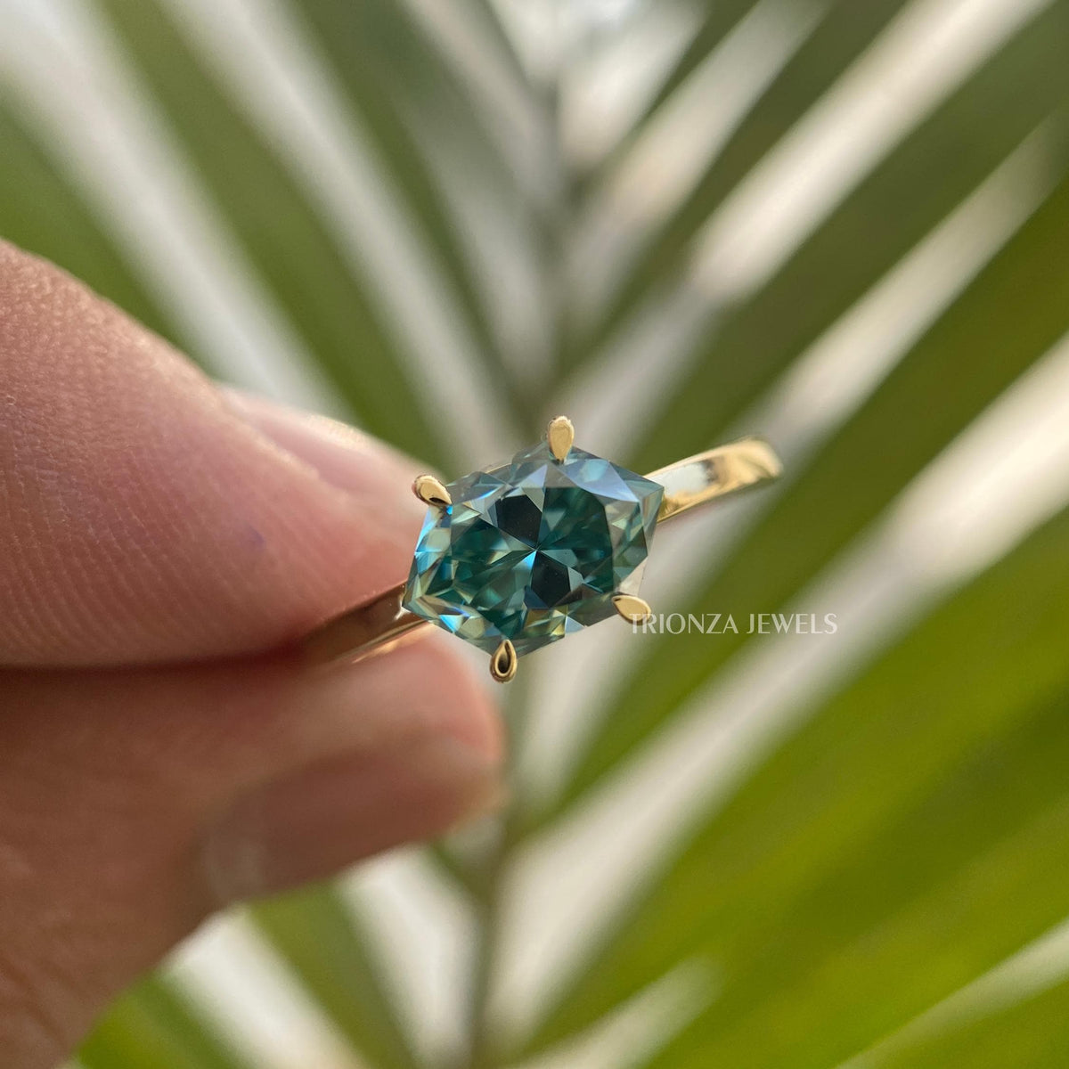 Handmade anniversary ring featuring a 1.25 CT hexagon cut teal sapphire in gold