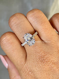 Oval lab grown diamond engagement ring with hidden halo pave setting in polished metal band