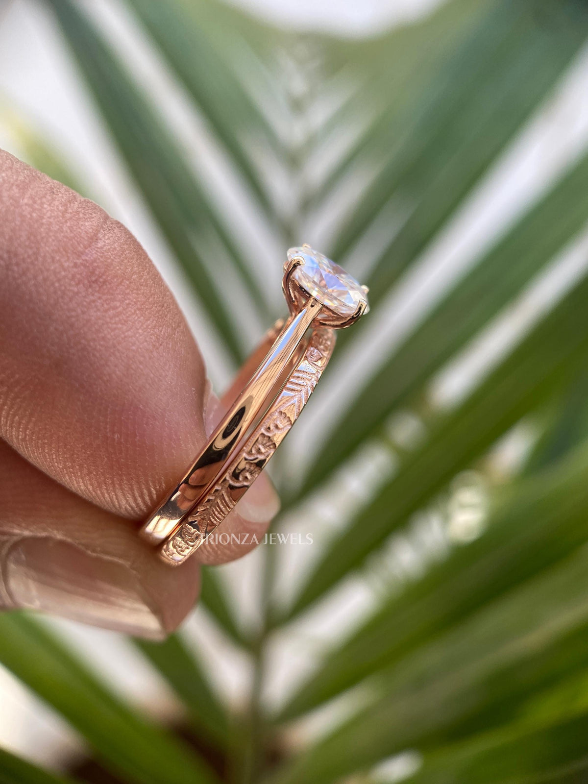 14k rose gold ring set displayed together highlighting the delicate oval solitaire design