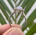 Round moissanite pave set wedding ring designed to complement the oval halo center stone