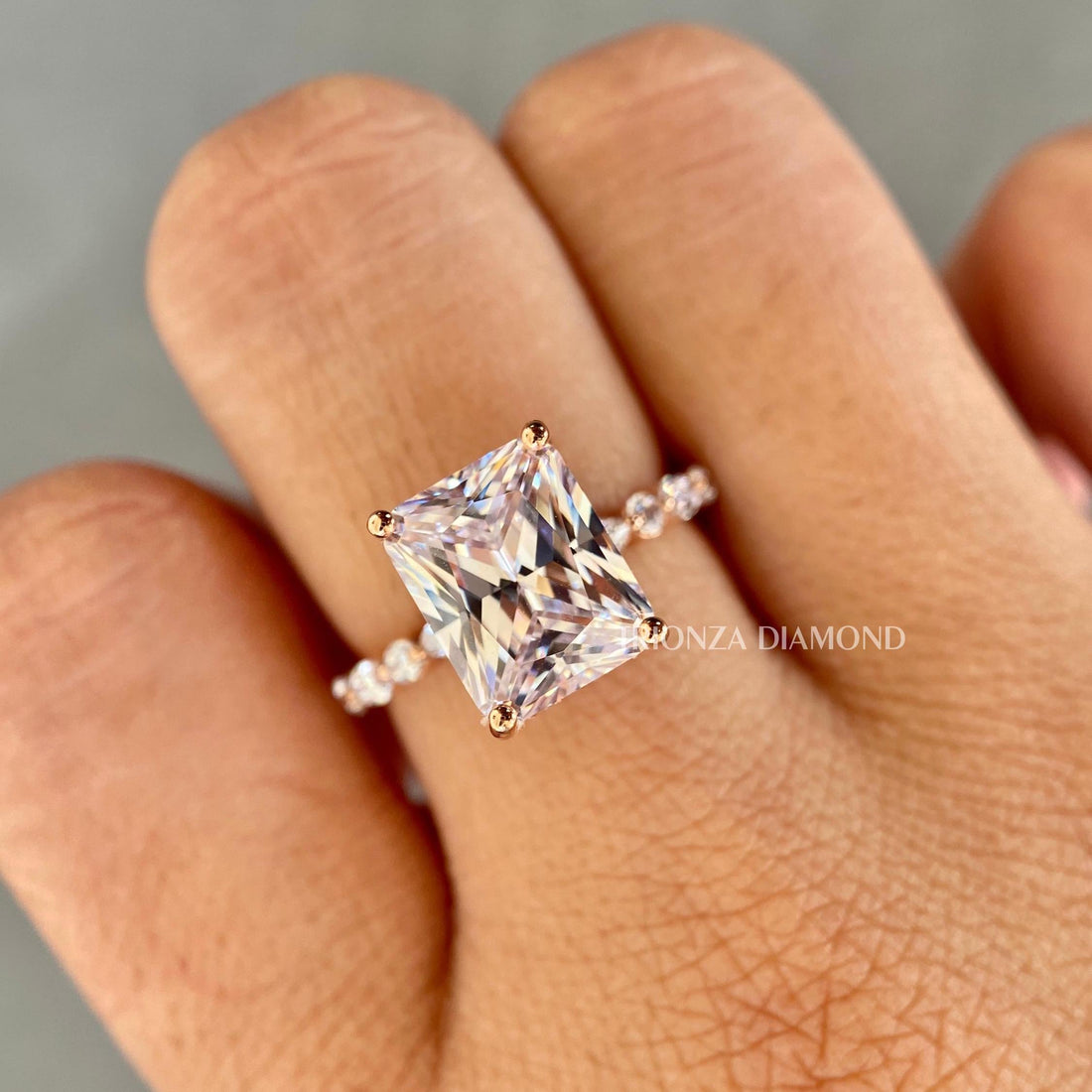 Radiant cut lab grown diamond engagement ring featuring a marquise round pave setting