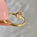 Side view of the ring showing the triangle cut and round cut accent diamonds