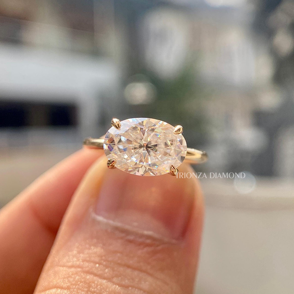 Oval cut lab grown diamond solitaire engagement ring set in 14k yellow gold prongs