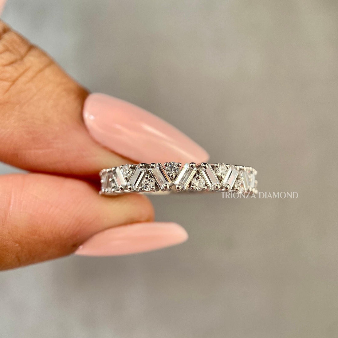 Zigzag half eternity wedding band featuring baguette and round cut lab grown diamonds