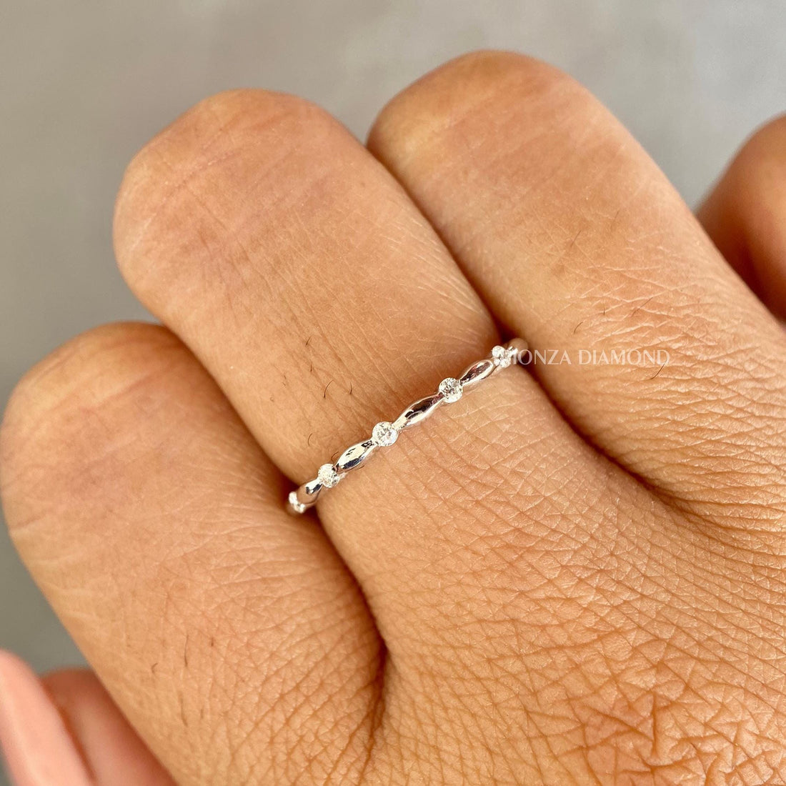 Vintage half eternity wedding band with round cut lab grown diamonds in a marquise dome design