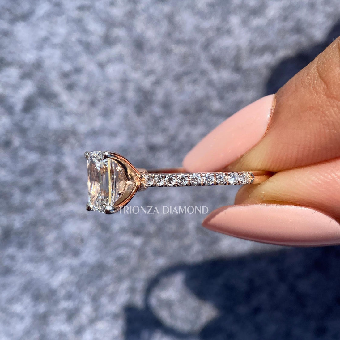 Emerald cut lab diamond ring featuring a 1.5 CT stone set in an 18K gold pave band