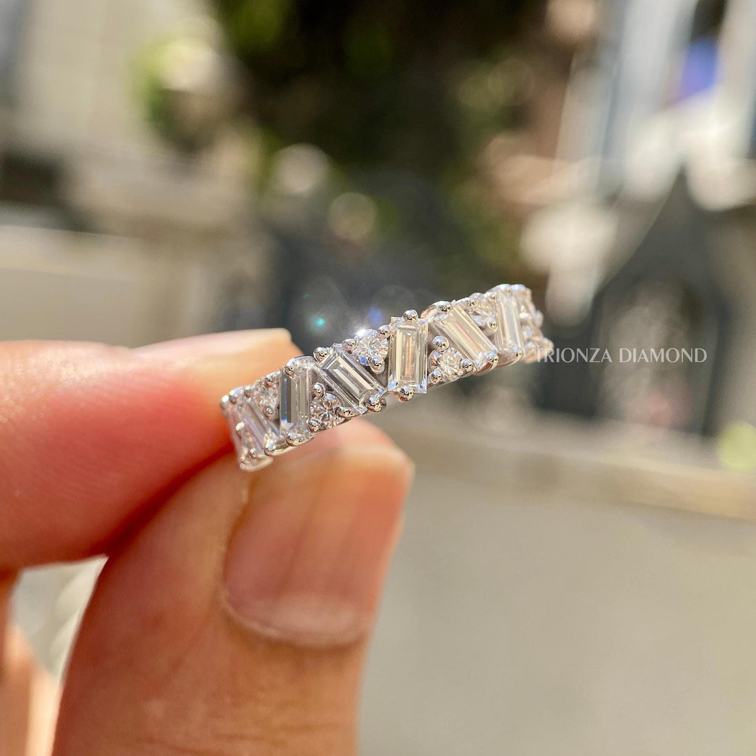 Baguette and round cut lab diamond zigzag wedding band displayed in a jewelry box