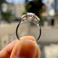 TrionzaDiamond oval three stone ring crafted with round side diamonds for a unique design