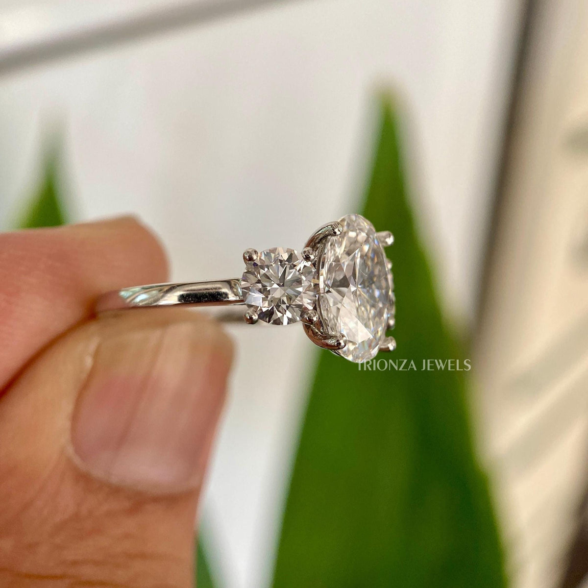 Close-up of the oval moissanite center stone showing its colorless VVS clarity