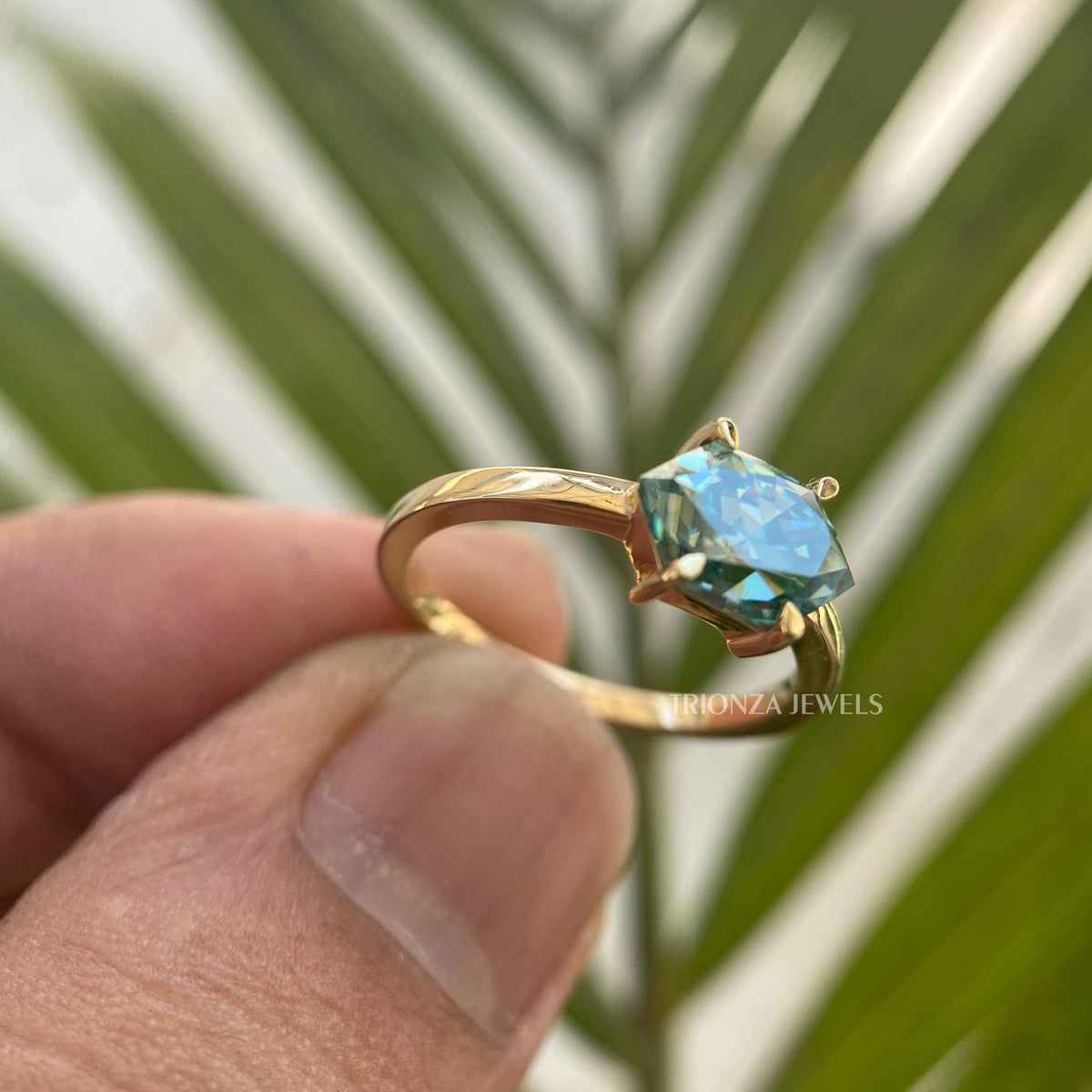 Green sapphire Dutch Marquise ring showcasing prong or halo setting details up close