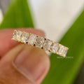 Stackable moissanite wedding band displayed alongside a matching bridal ring set