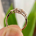 Close-up of the round cut moissanite center stone paired with pear cut side stones