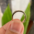 Solid gold chevron eternity band displayed in a jewelry box with smooth fabric included