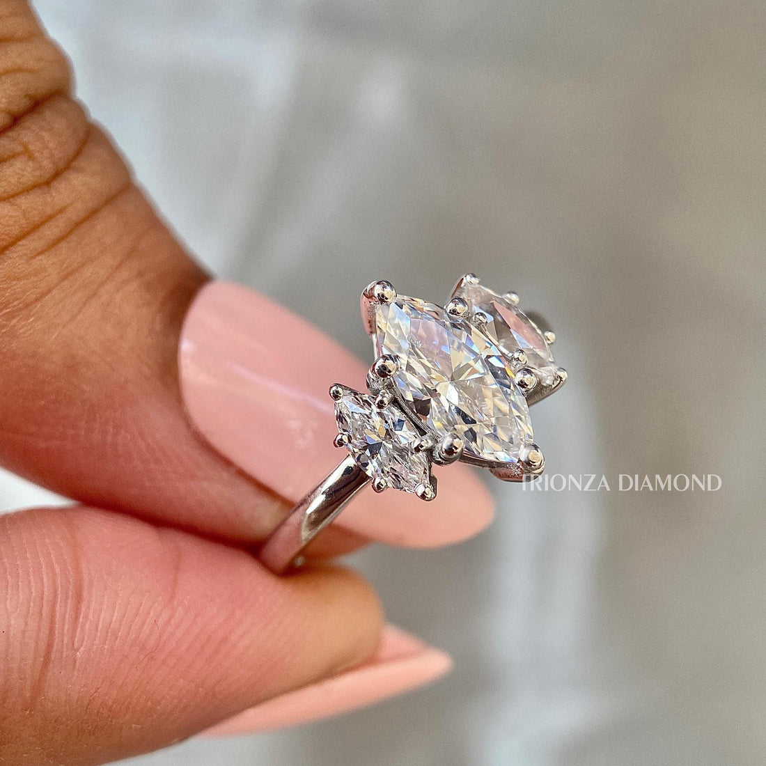 Marquise cut lab grown diamond trilogy ring showcasing a 2.00 CT center stone in E/VS1 quality