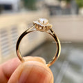 Woman wearing the marquise diamond halo ring, close-up view on her hand
