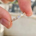 Stackable baguette diamond band shown alongside a matching ring for a layered look