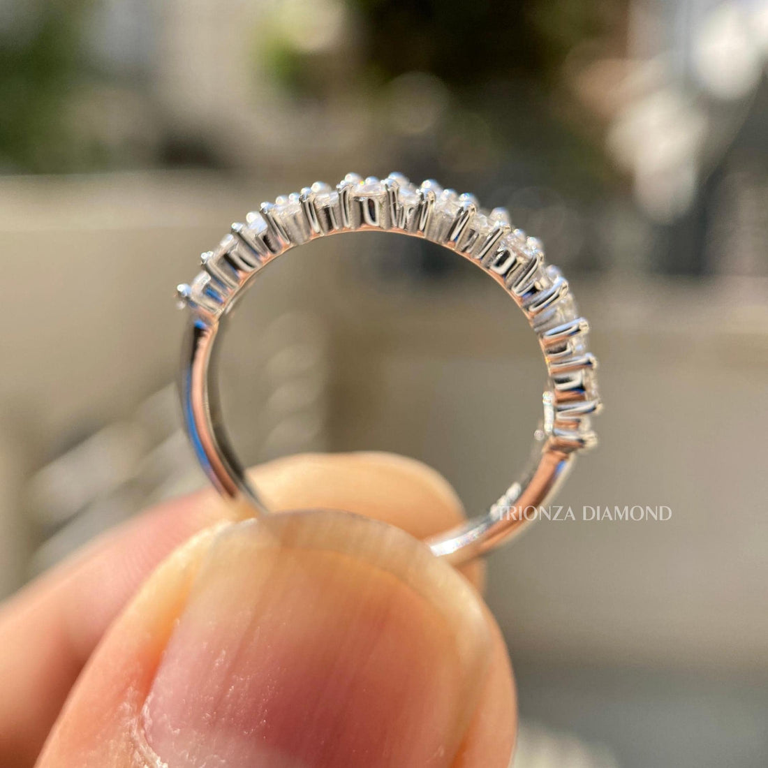 Baguette and round cut lab diamond zigzag wedding band displayed in a jewelry box