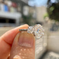 Side view of the oval cut center diamond flanked by round cut side stones in the setting