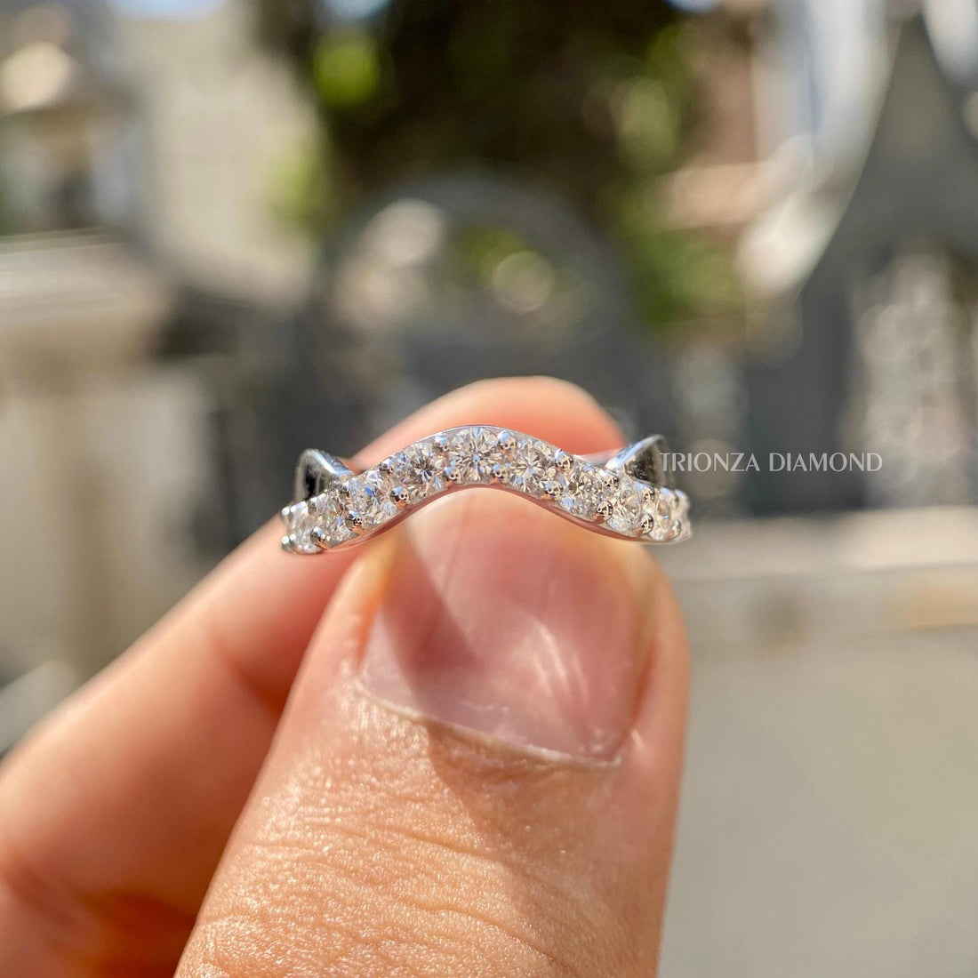 Round cut lab grown diamond curved wedding band designed with a chevron style for women