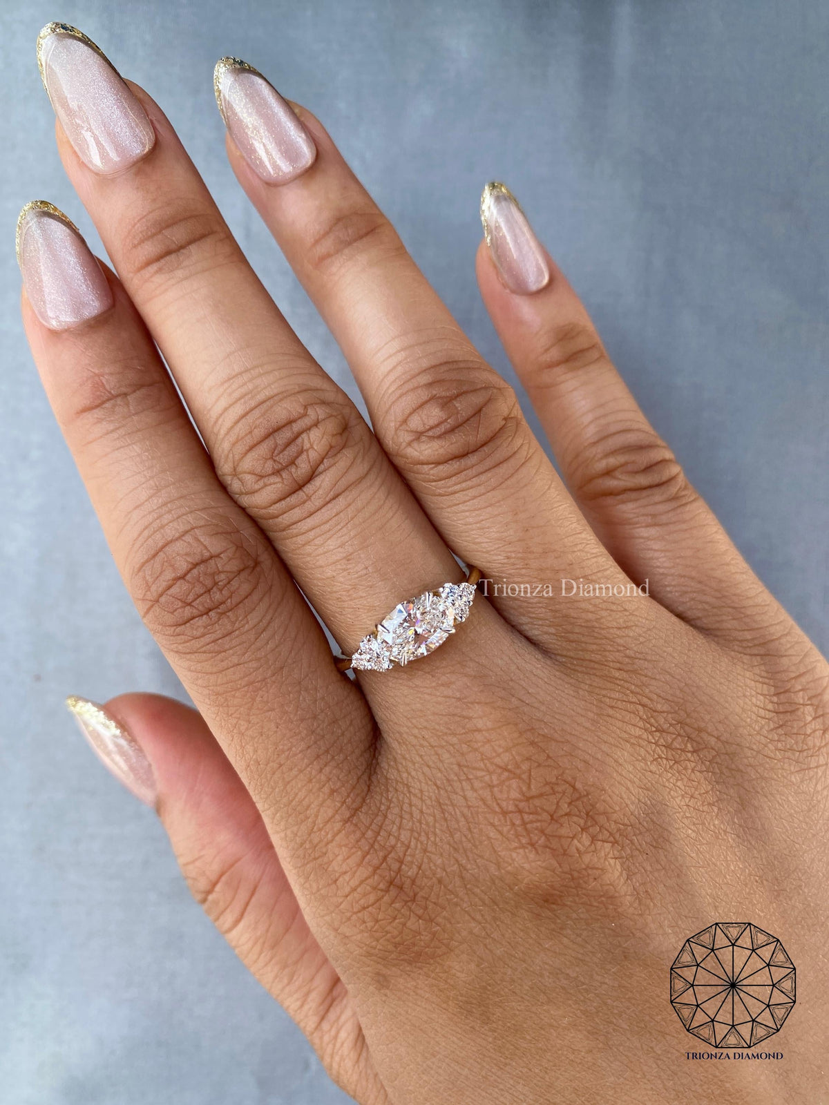 Woman wearing the oval east-west diamond ring showing its modern sophisticated design