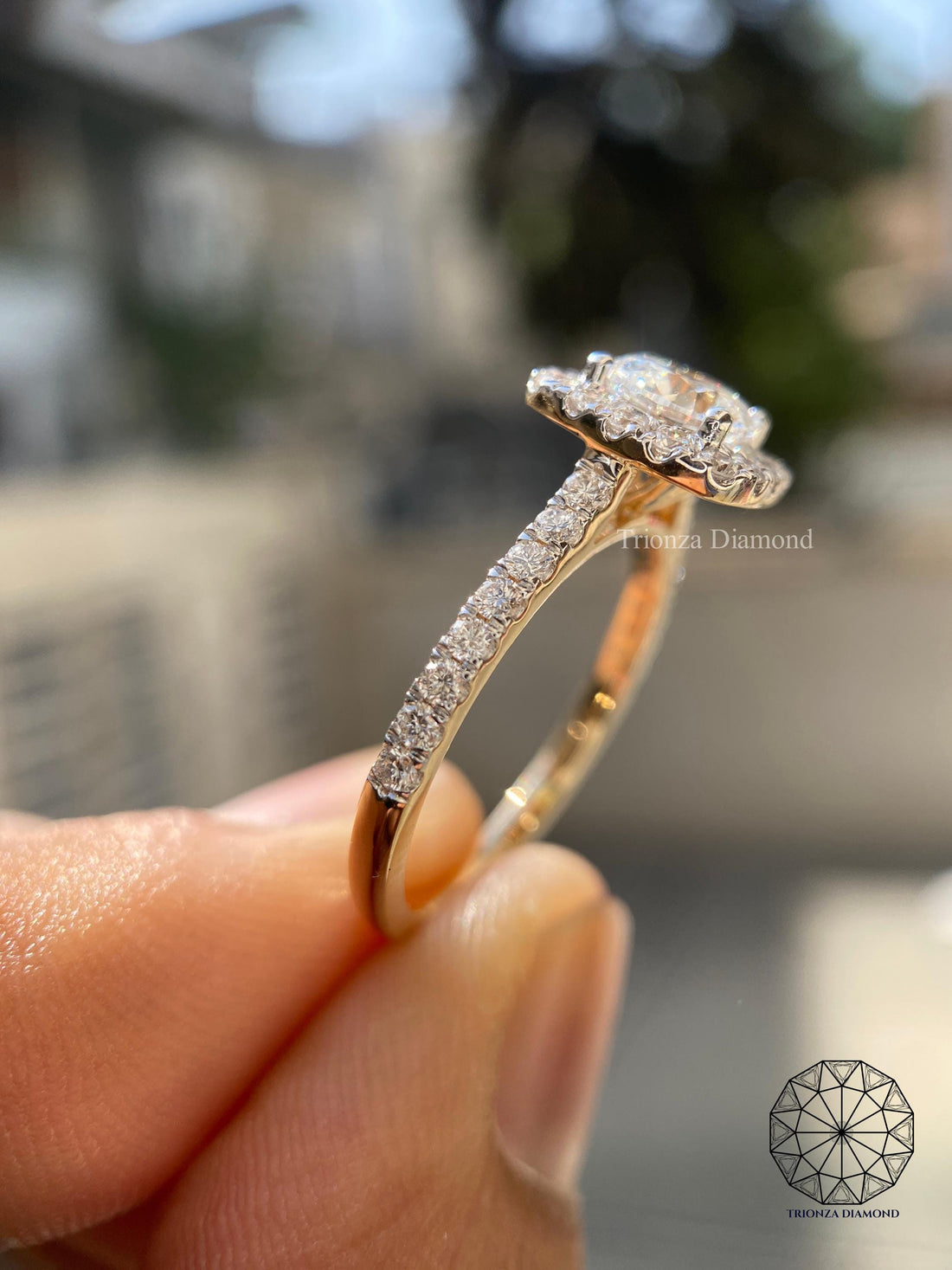 Round cut lab grown diamond halo ring displayed in 14K two-tone gold setting