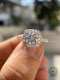 Close-up of the round cut diamond secured in a cushion halo pave setting