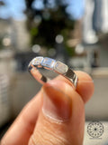 5x3mm emerald cut lab grown diamond band displayed to highlight its excellent polish and symmetry