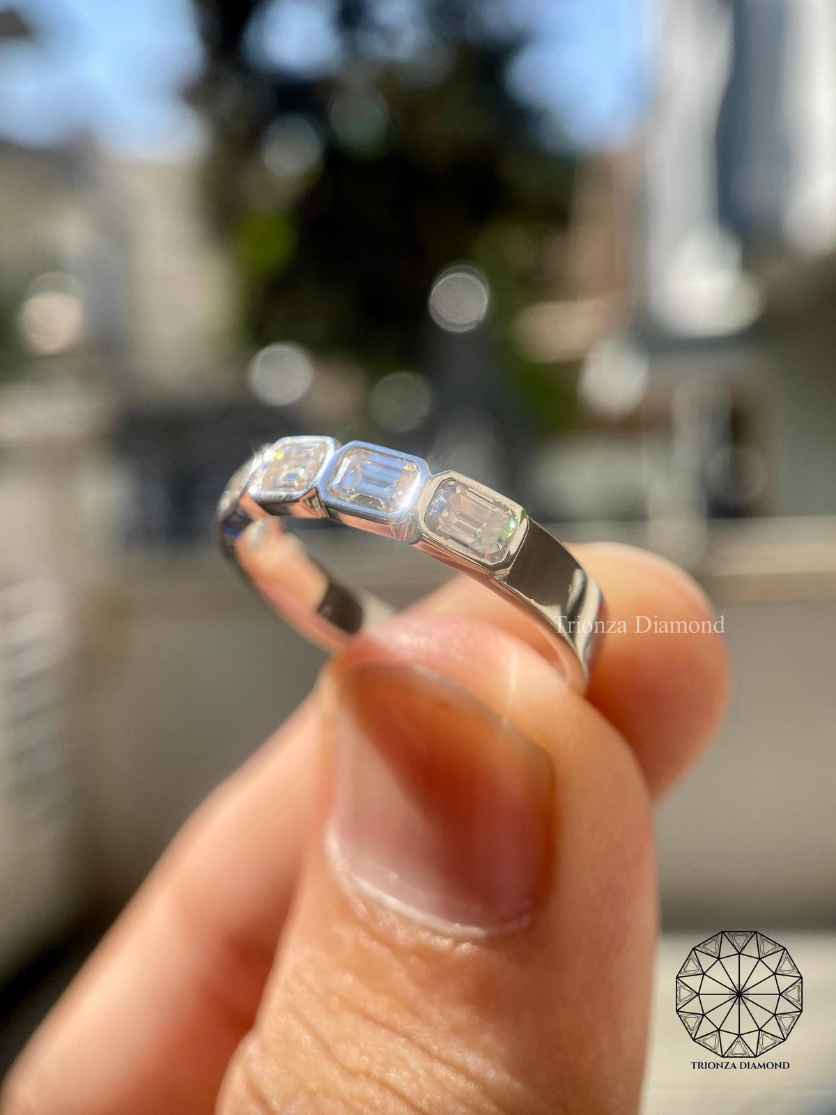 5x3mm emerald cut lab grown diamond band displayed to highlight its excellent polish and symmetry