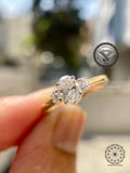 Oval cut lab grown diamond engagement ring with round side stones in 14K yellow gold