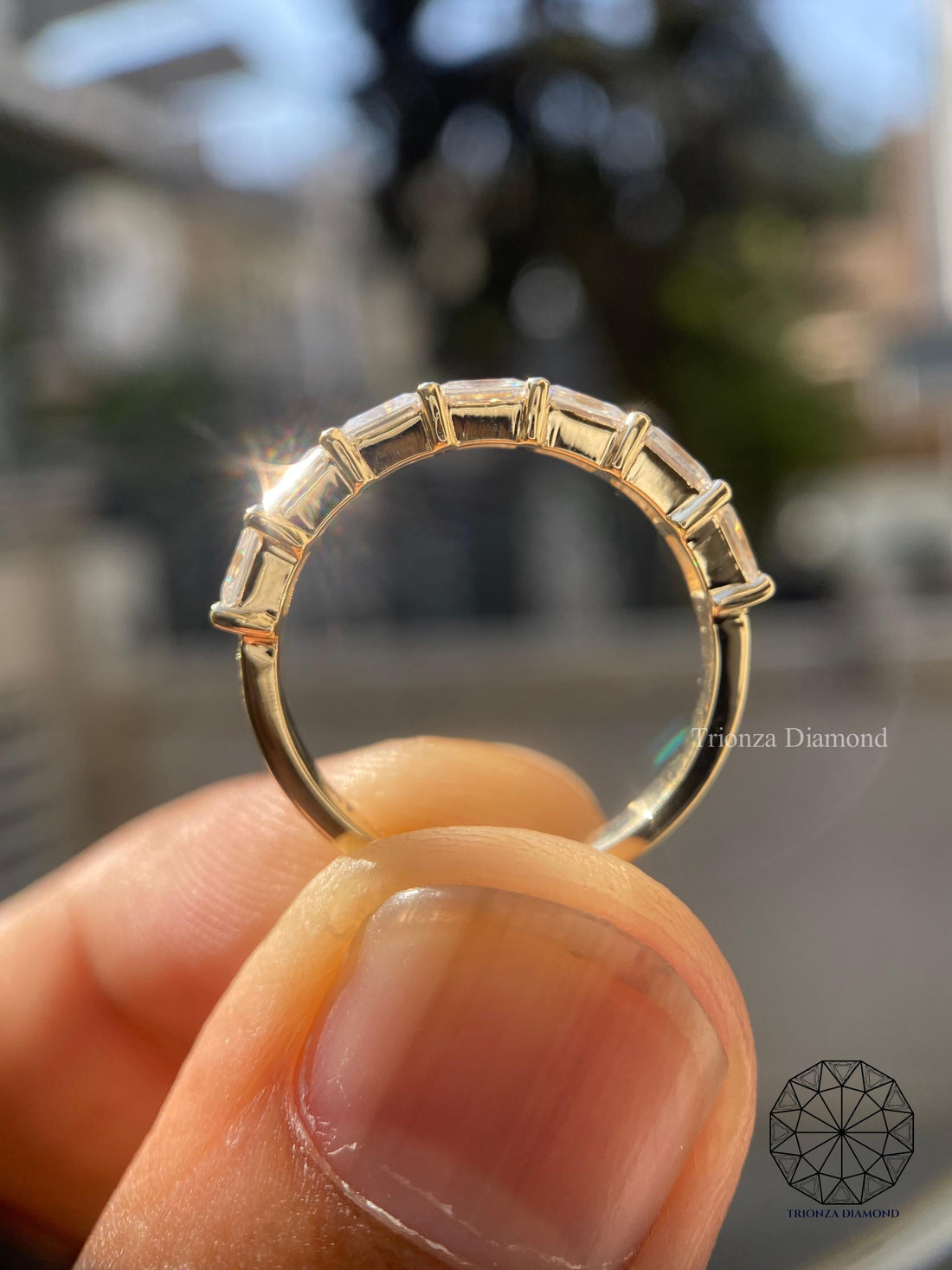 East west radiant cut lab grown diamond wedding band displayed with elegant stacking style