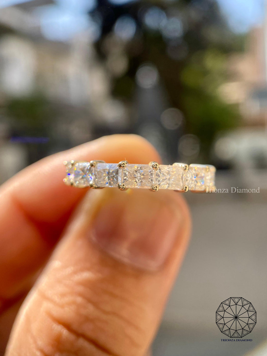 East west radiant cut lab grown diamond wedding band displayed with elegant stacking style