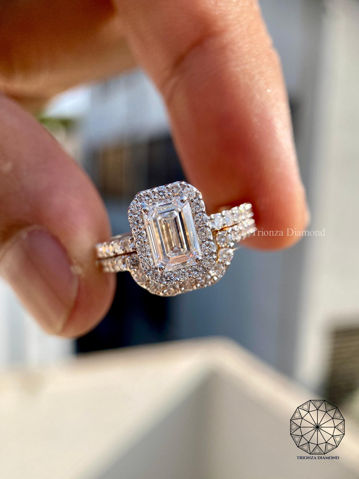 Emerald cut lab grown diamond engagement ring with halo pave setting and matching wedding band