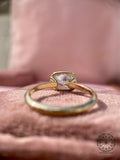 Bezel set engagement ring crafted to protect the elongated cushion cut diamond
