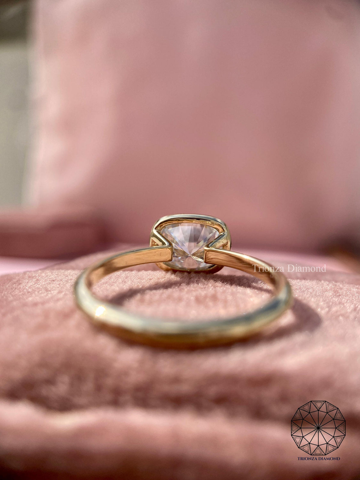 Bezel set engagement ring crafted to protect the elongated cushion cut diamond