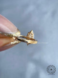 Solitaire engagement ring featuring a marquise shaped diamond in a cathedral setting